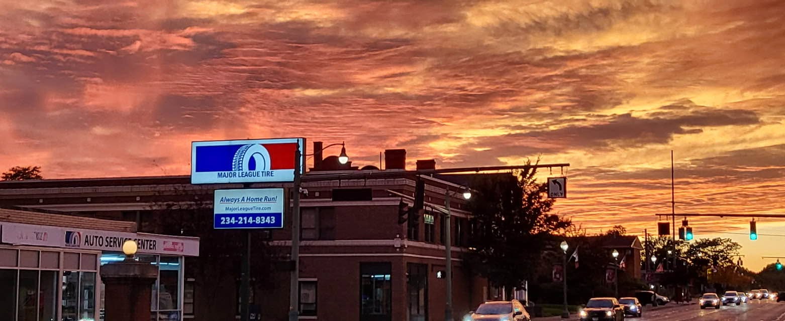 Major League Tire sign over Tuscarawas Street in Canton at sunset